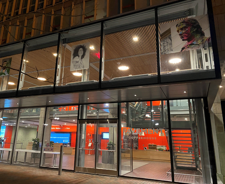 exterior view of the two-story glass facade and entrance to the Smith Campus Center in Harvard Square